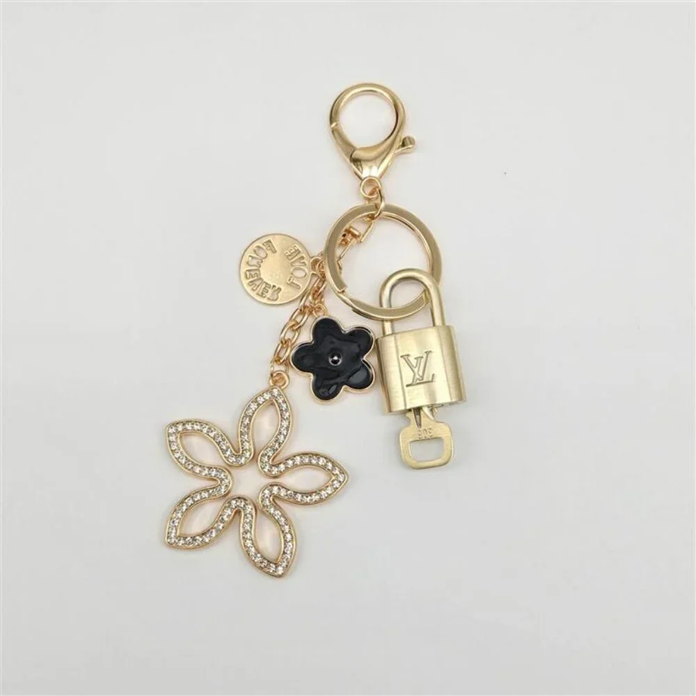 Louis Vuitton Gold-Tone Crystal Flower Keychain with Black Accent